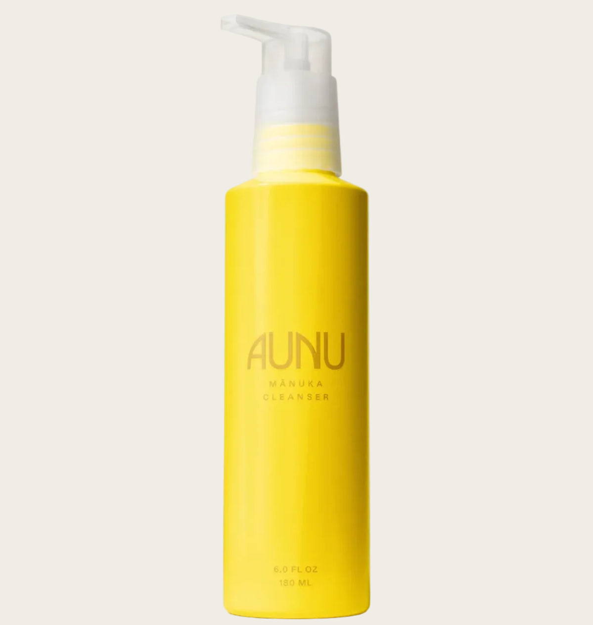 Yellow bottle with pump labeled 'AUNU' on a beige background