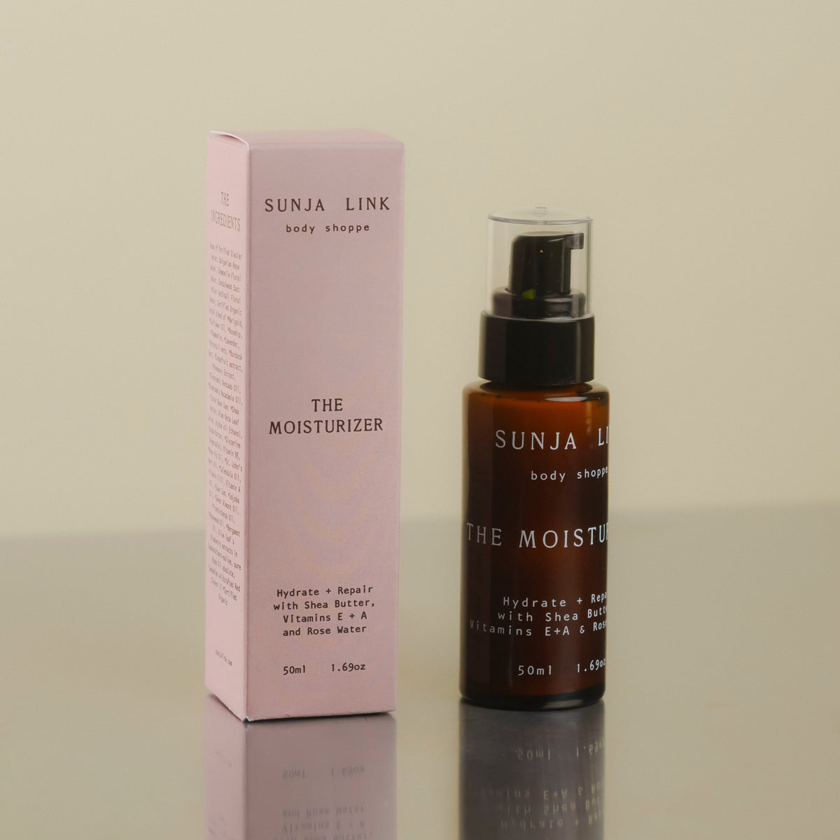 Sunja Link moisturizer bottle and box on a reflective surface with a neutral background