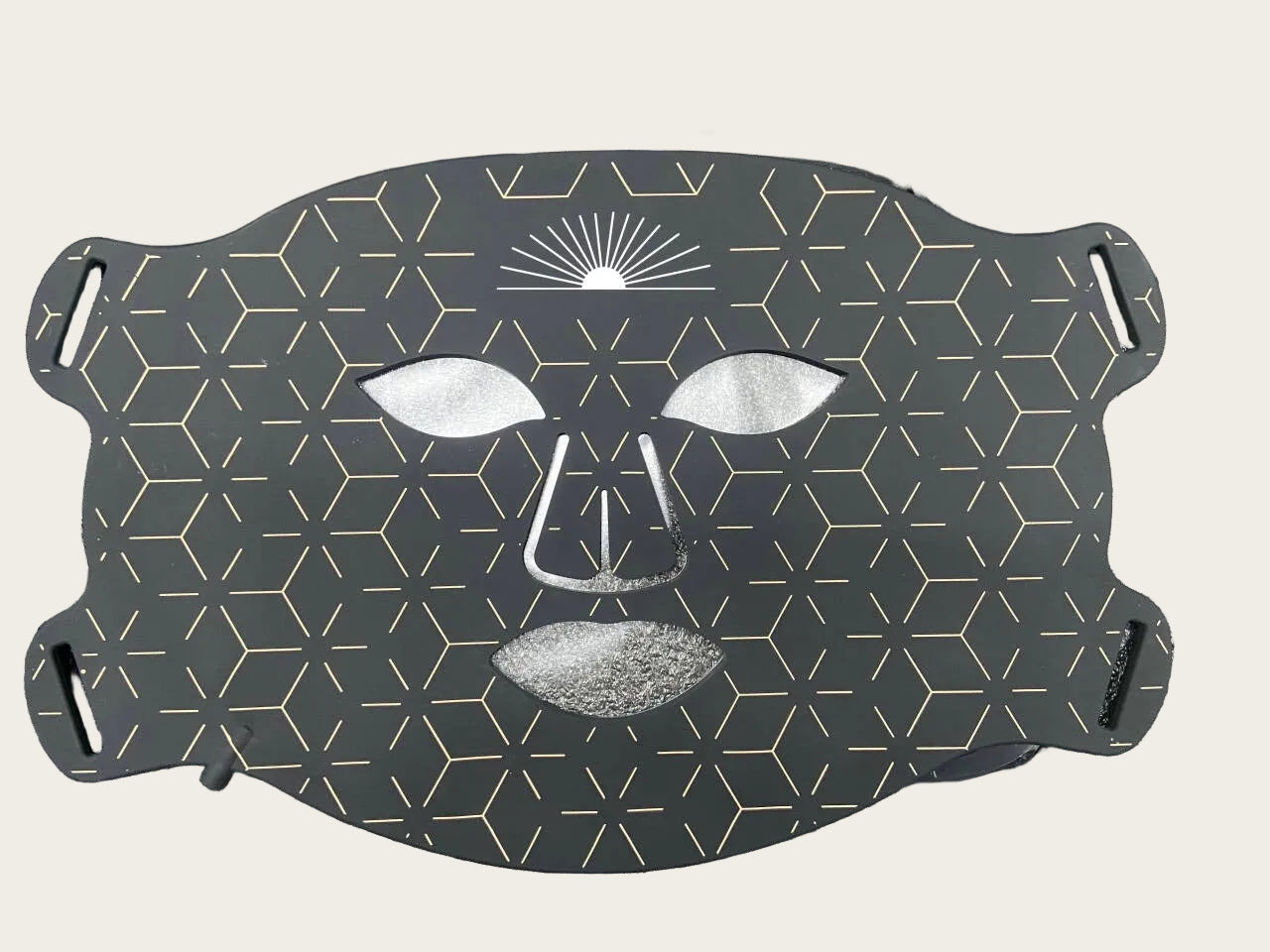 Geometric face mask with black and white design on a textured surface