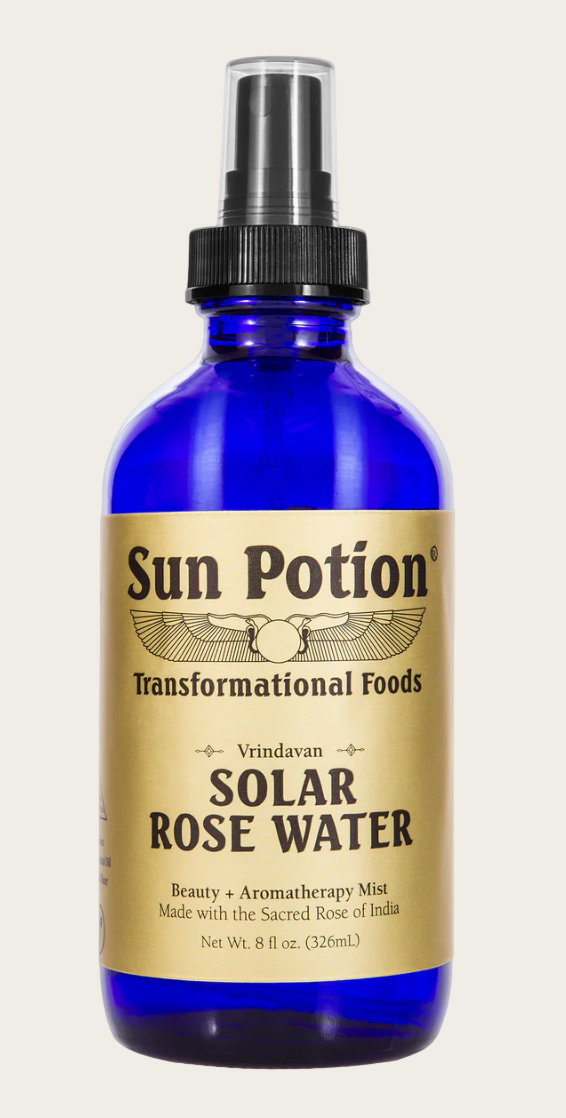 Blue bottle of 'Sun Potion' Solar Rose Water on a white background