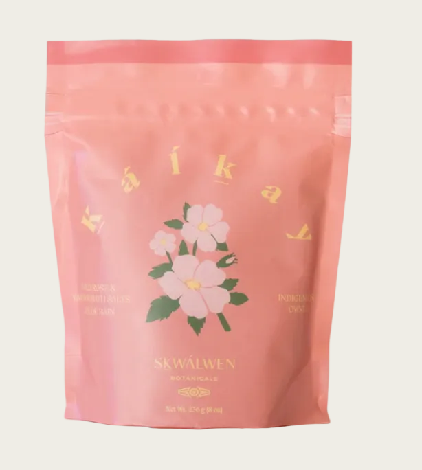 Pink package with floral design and 'Skwalwen' branding on a light gray background