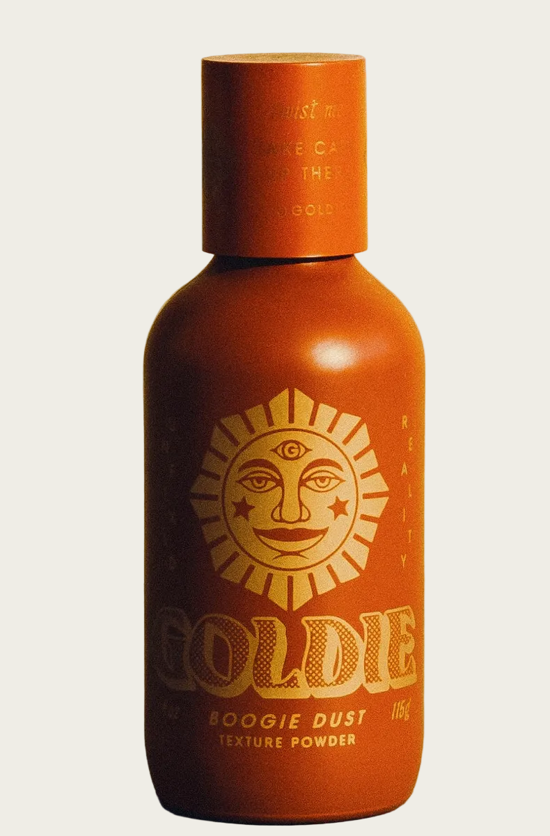 Brown bottle with sun design and 'Goldie' branding on a beige background